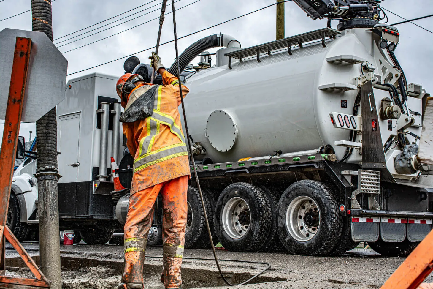 Subsurface utility engineering crew working beside hydro-vac equipment