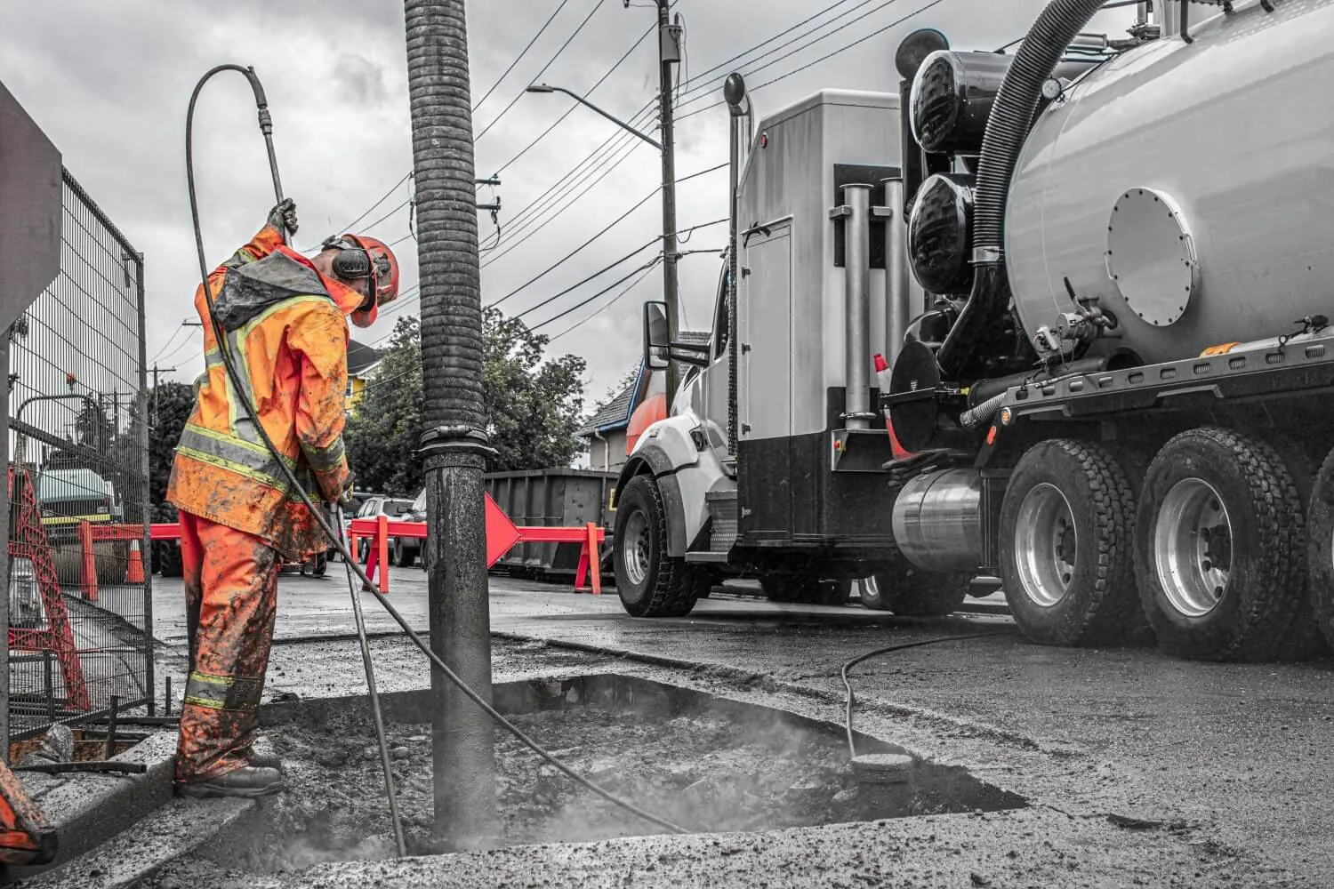 Subsurface utility engineering crew using hydro-vac equipment